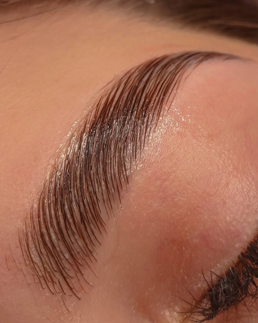 Skin by Jacqueline brow lamination in Scottsdale, AZ showing full, perfectly groomed eyebrows with a sleek, polished appearance.