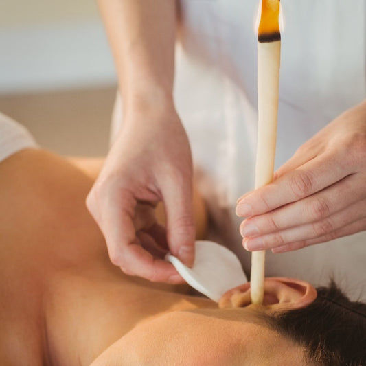 Skin by Jacqueline ear candling in Scottsdale, AZ, showing a relaxing scene with a lit ear candle for ear wellness and relaxation.